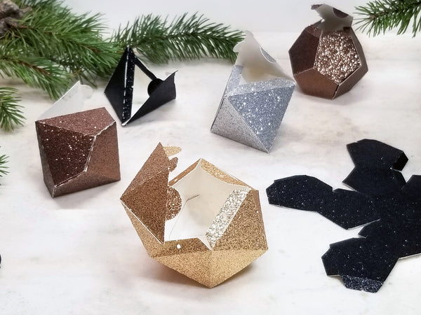 Metallic glitter favor boxes with their lids open