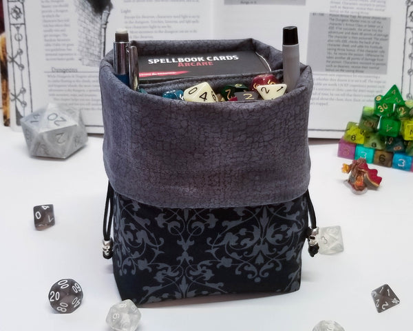 Black and grey damask print dice bag. Folded down to show grey lining.