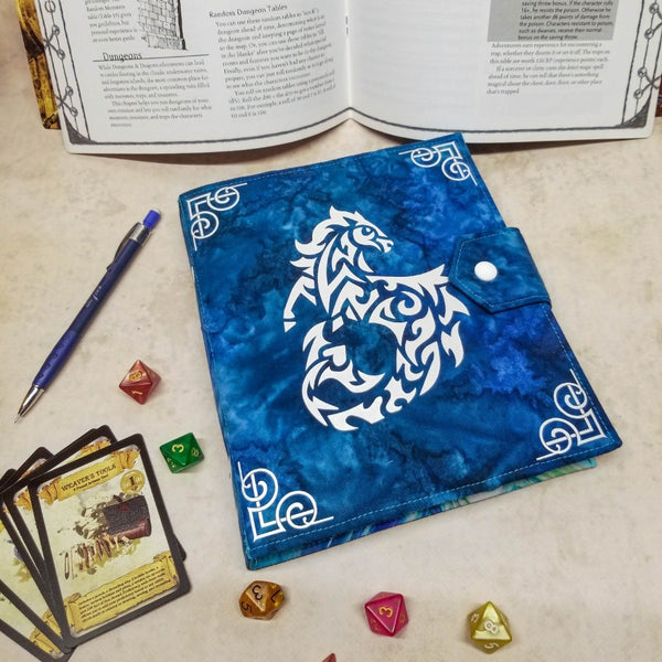 A dark blue binder with snap closure. Cover is decorated with a stylized hippocamp
