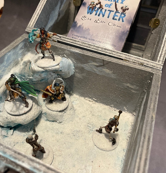 Army of Winter Diorama includes 5 Handpainted Minis, in a Winter Scene enclosure with glass viewing window.  Comes with an adventure including map, and pregenerated character cards. 
