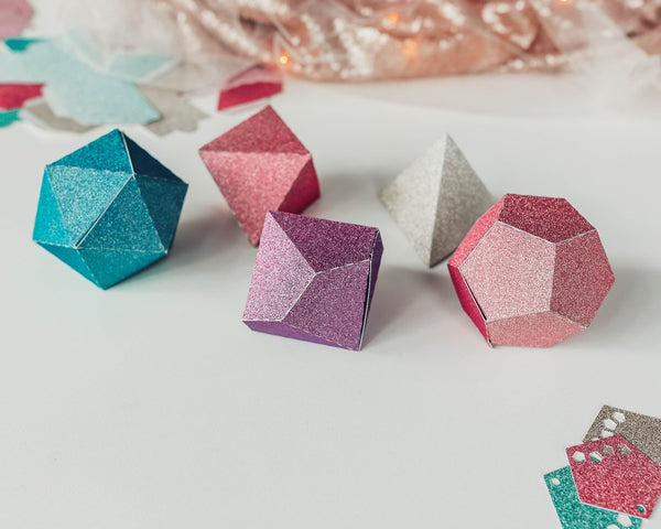 5 favor boxes in glittery pastel rainbow colors.
