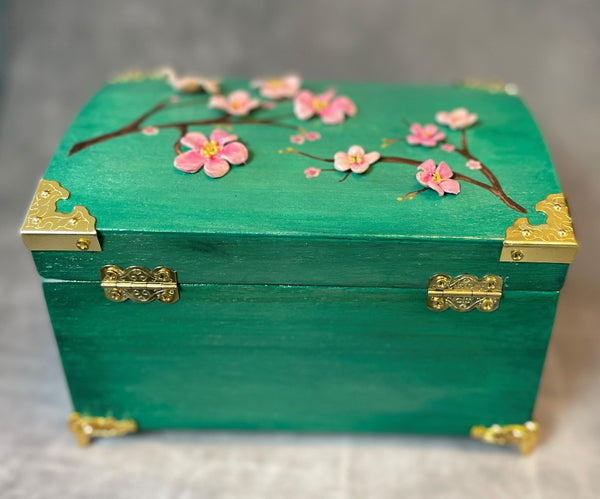 Cherry blossom chest in a shimmery mint green with 3D cherry blossoms and brass hardware. Back View of Hinges