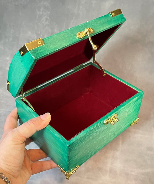 Cherry blossom chest in a shimmery mint green with 3D cherry blossoms and brass hardware.  Open and held in the hand