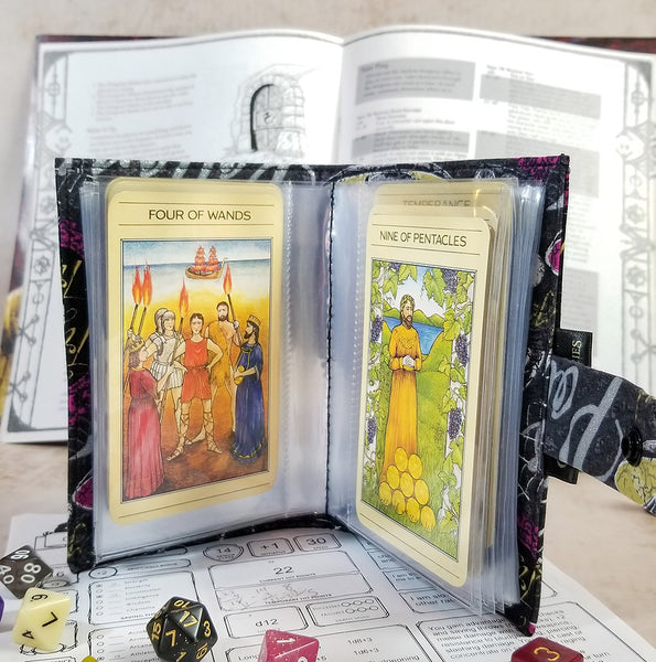 tarot-sized spellbook in a metallic silver halloween print.  Open to show interior stitching and tarot cards.