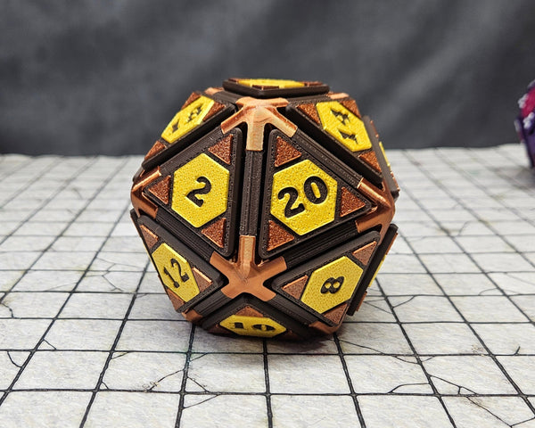 A bronze D20 fidget clicker sits on a ttprg map grid