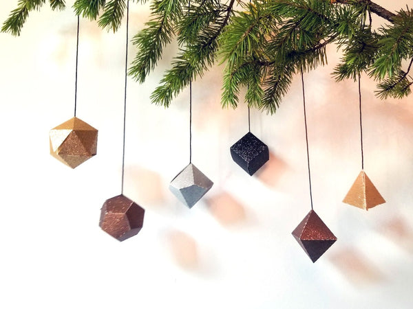 Metallic glitter favor boxes hanging in a row