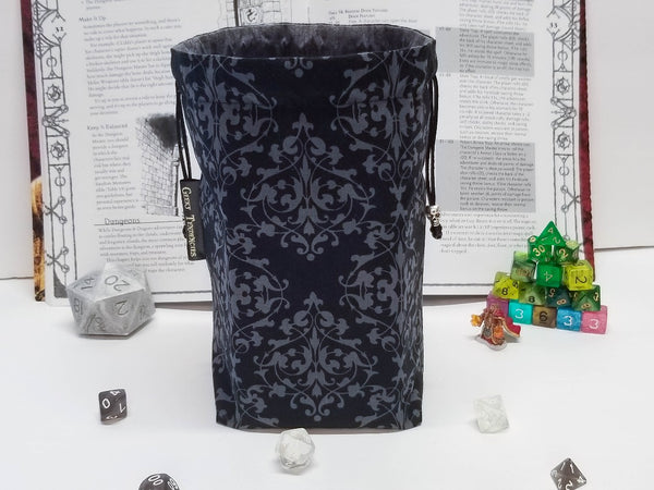 Black and grey damask print dice bag with skull beads. Bag open