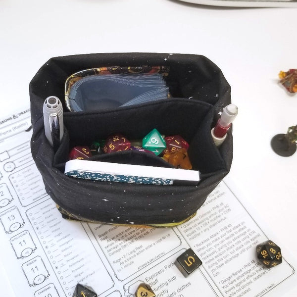 Inside of the Cosmos Dicebag showing black starry interior and pockets. 
