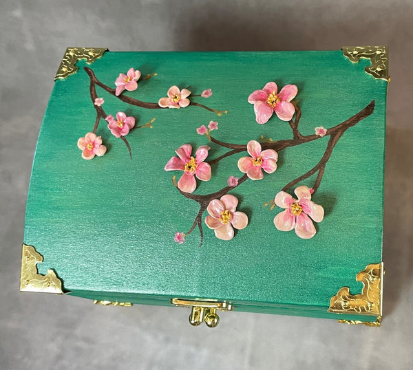 Cherry blossom chest in a shimmery mint green with 3D cherry blossoms and brass hardware.  top View