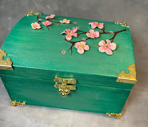 Cherry blossom chest in a shimmery mint green with 3D cherry blossoms and brass hardware. 